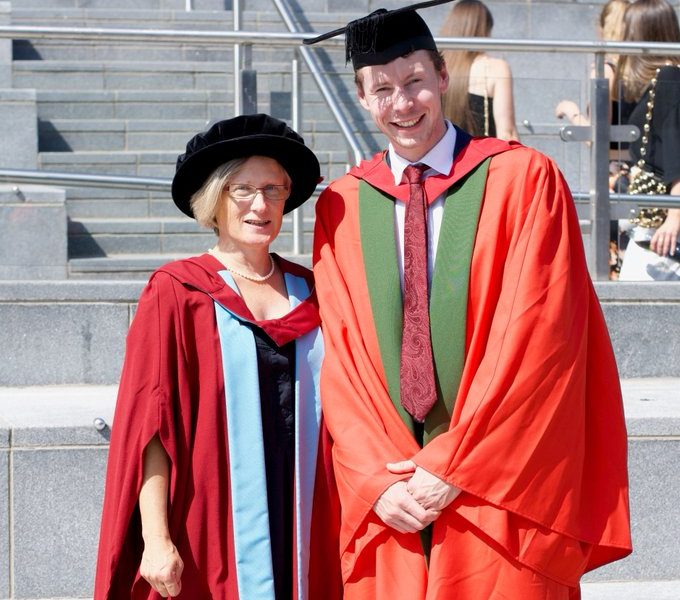 Graduation 2019 photo of a young man with the chancellor of the university