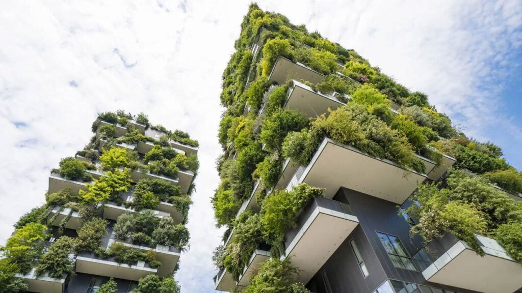 Green Infrastructure: How can we build a sustainable future? Image for Festival of Debate event. The picture is of 2 tall buildings covered in green - not in a nature is reclaiming them post-apocalyptic way, the greenery looks intentional. 