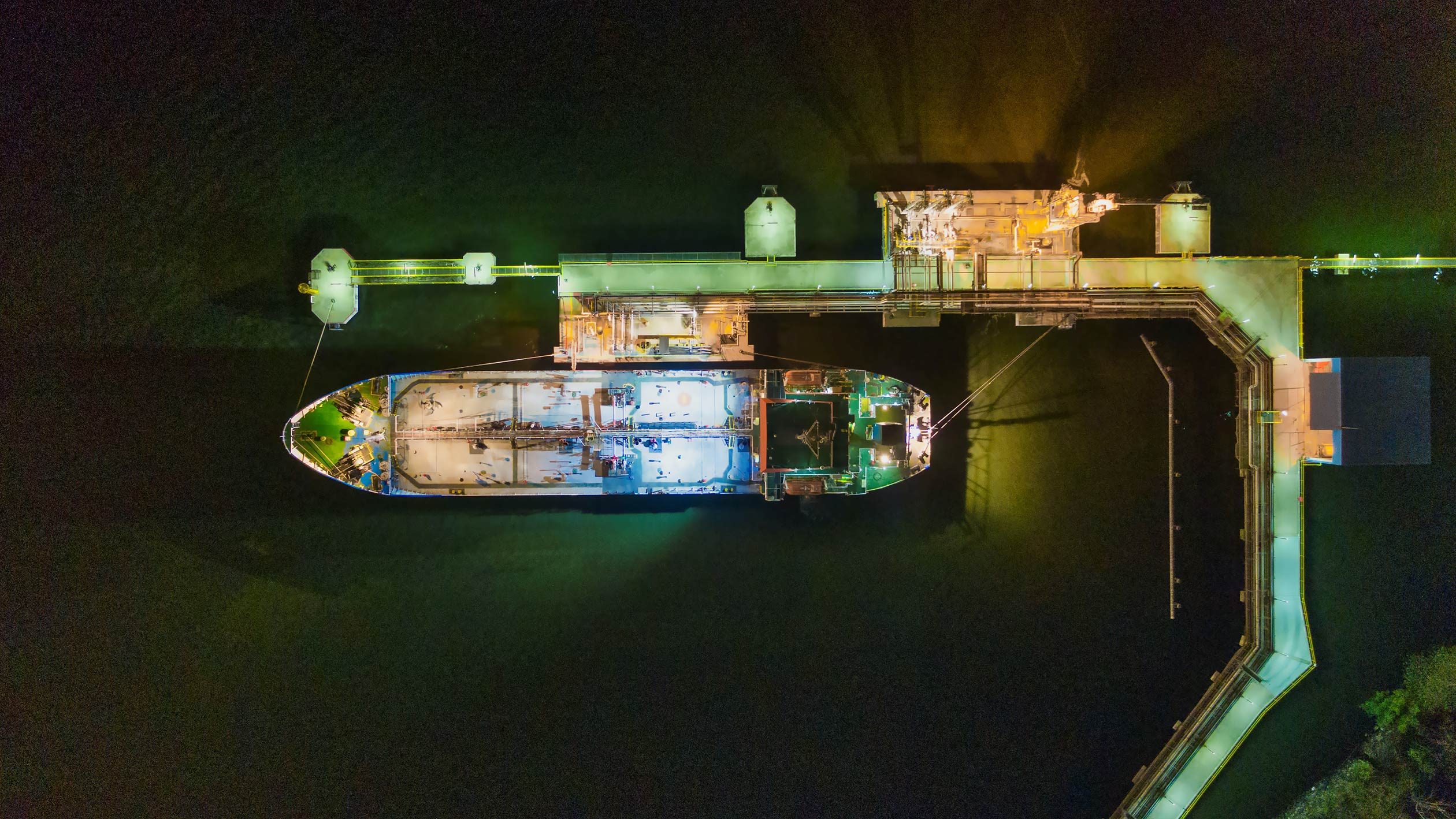 A huge container ship photographer from above in port at night. 
