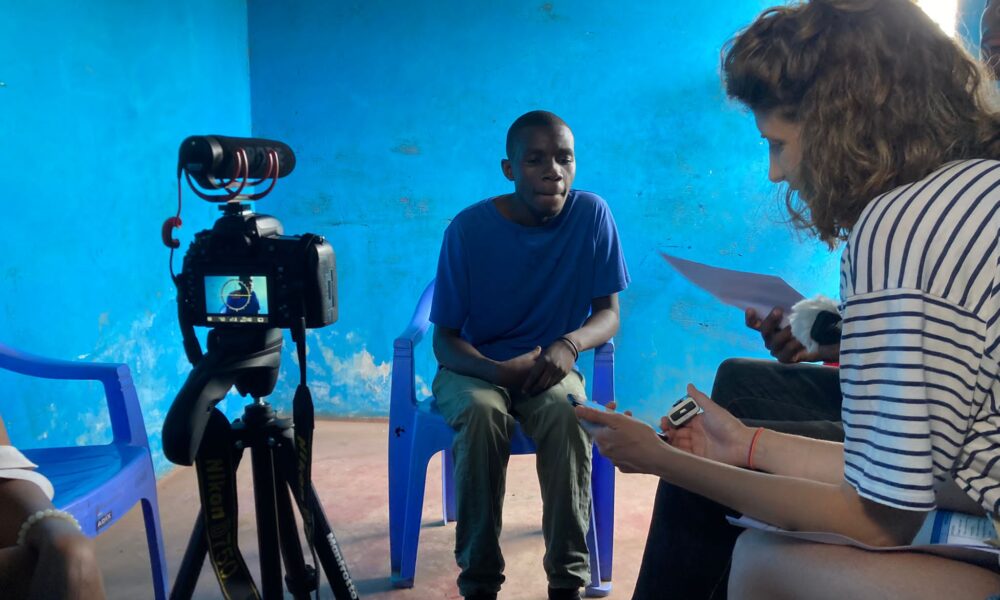 A man in Nairobi sitting in front of a camera being filmed for an interview