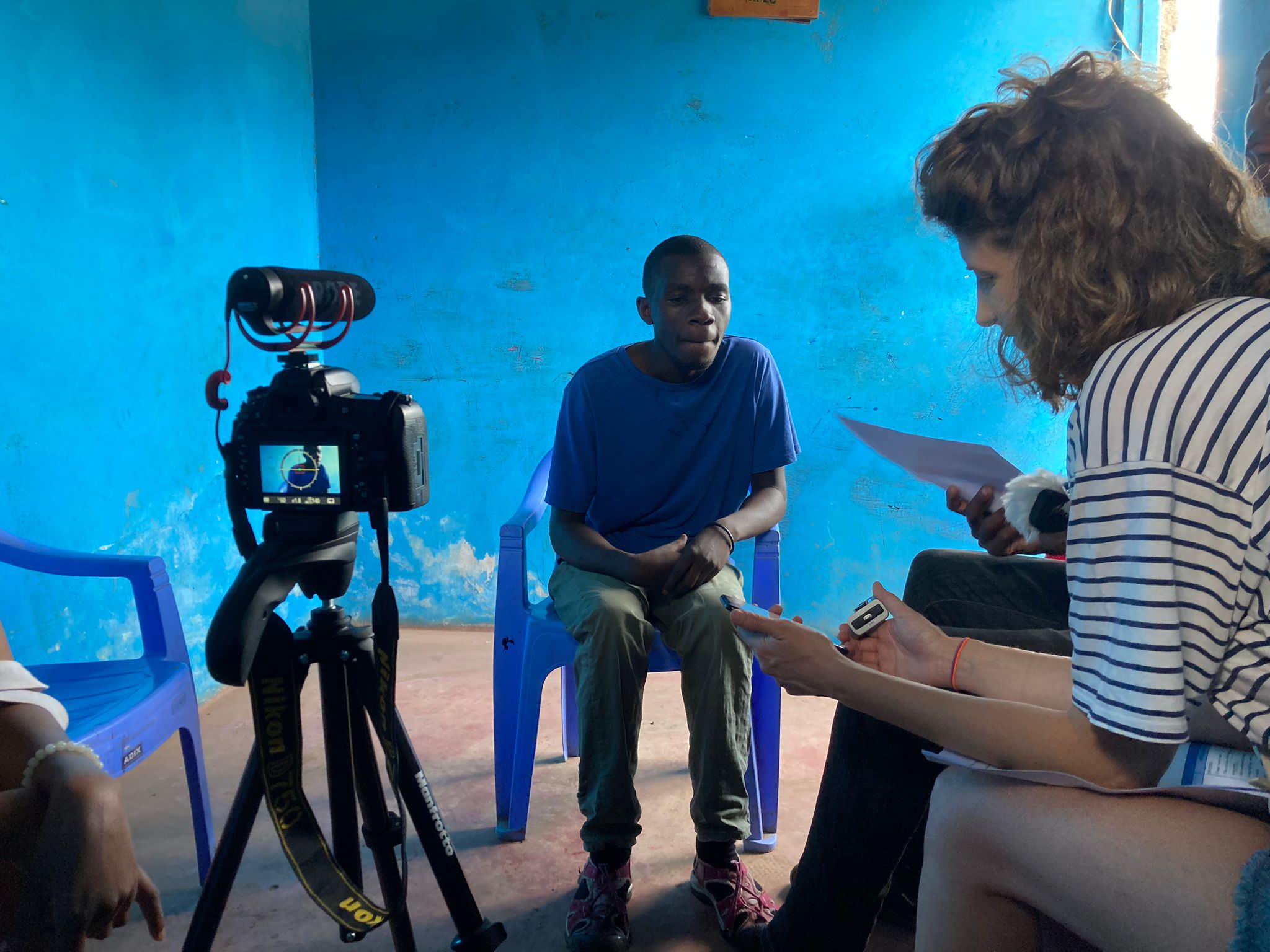 A man in Nairobi sitting in front of a camera being filmed for an interview